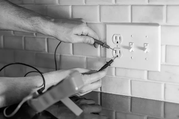 electrician testing outlet